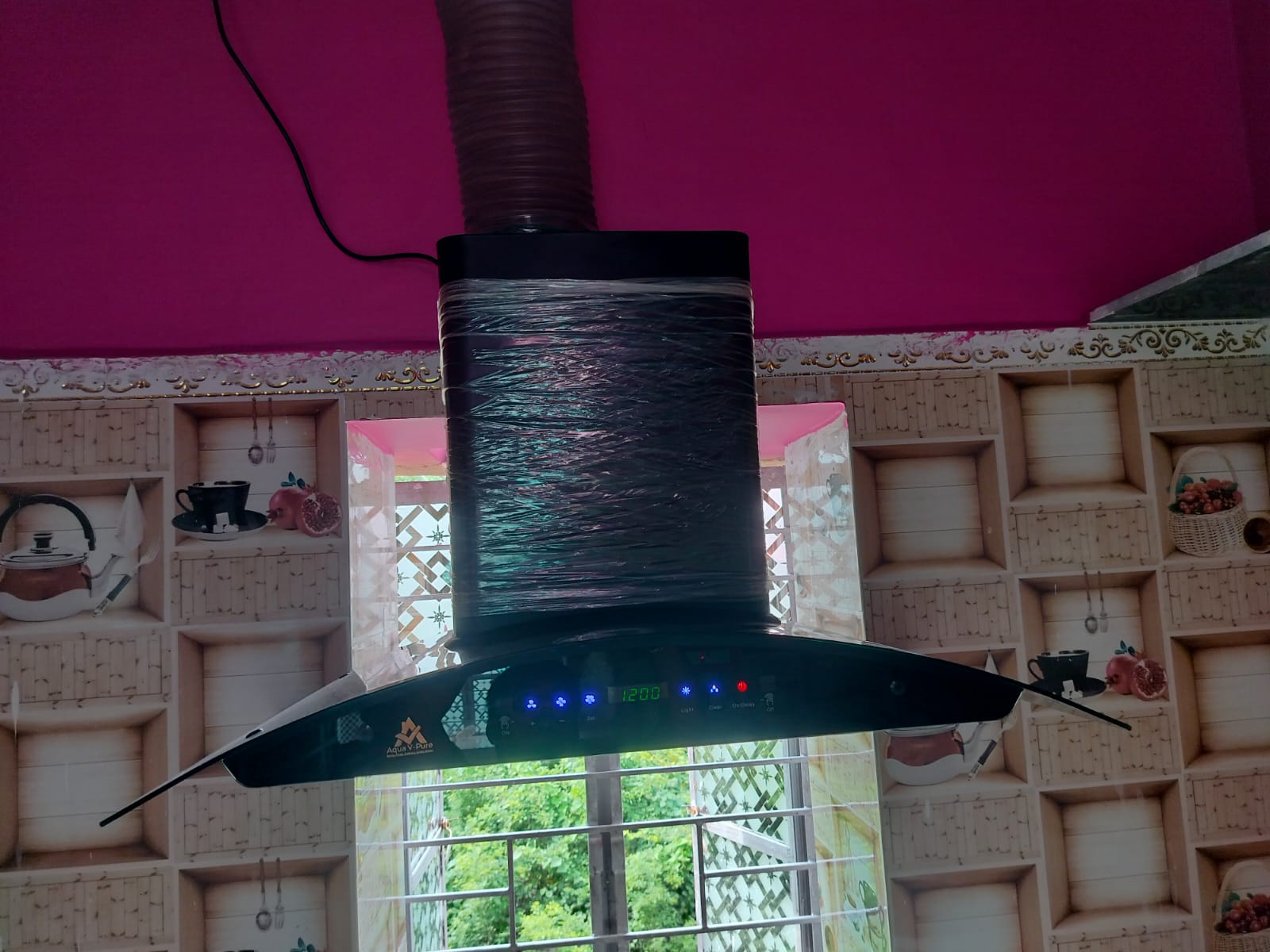 NexElectra kitchen chimney installed above a modular kitchen countertop in West Bengal
